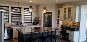 Kitchen includes thick granite counter tops with a rough-cut edge, island top is custom natural wood plank.