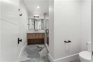 Bathroom featuring toilet, vanity, and tile floors