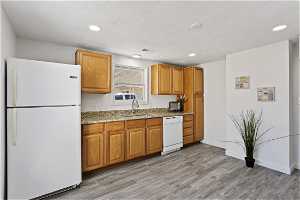 Kitchen w/ granite tops, fridge, dishwasher, sink,