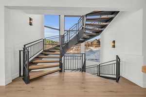 Stairs featuring wood-type flooring