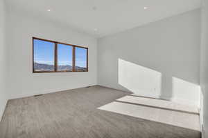 Carpeted empty room featuring a mountain view