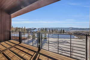 Snow covered deck featuring a mountain view