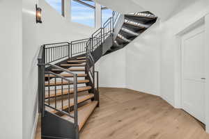 Stairway featuring hardwood / wood-style flooring