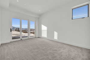 Carpeted spare room featuring a mountain view