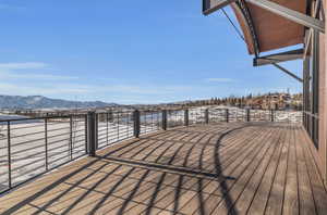 Snow covered deck with a mountain view