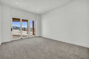 Carpeted spare room featuring a mountain view