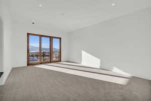 Carpeted empty room featuring a mountain view