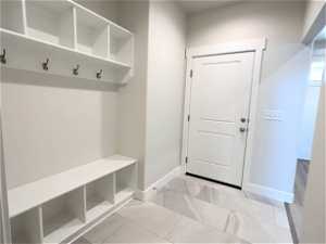 Spacious mud room with access to garage.