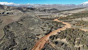 Aerial overview of property's location featuring a mountainous background