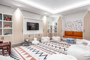 Living room with light hardwood / wood-style floors and wood walls