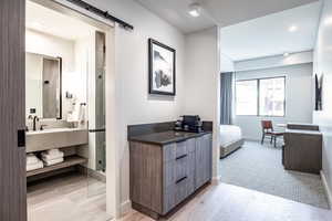 Bathroom featuring an enclosed shower, vanity, and hardwood / wood-style flooring