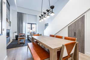 Dining area with a high ceiling and light hardwood / wood-style flooring