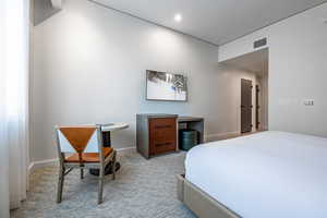 Bedroom featuring light colored carpet