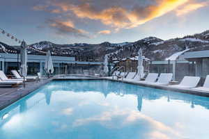 Snow covered pool featuring a mountain view