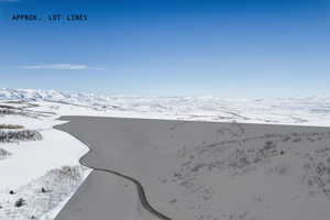 Snowy aerial view featuring a mountain view