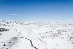 Snowy aerial view featuring a mountain view