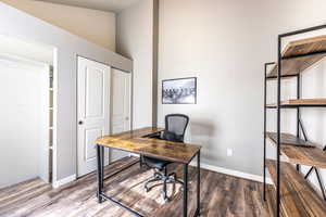 Office featuring wood-type flooring and lofted ceiling