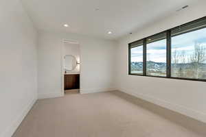 3rd bedroom Unfurnished bedroom featuring a mountain view, light colored carpet, and ensuite bath