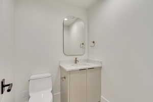 Bathroom featuring vanity and toilet