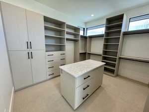 Primary bedroom walk in closet featuring optional washer dryer area