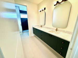 Bathroom featuring tile patterned flooring and vanity