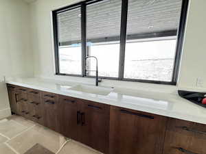 Kitchen with dark brown cabinetry and sink duel dishwashers