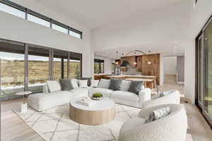 Living room featuring views from both sides, and a towering ceiling