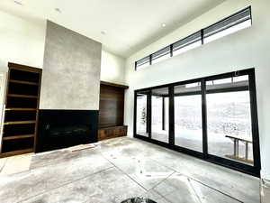 living room with a venetian plaster wall towering ceiling