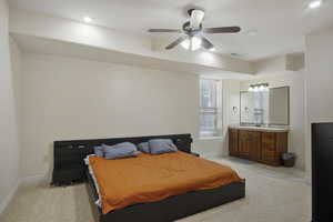 Guest bedroom with a ceiling fan and natural light, full bath