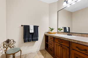 Bathroom featuring tile patterned floors and vanity
