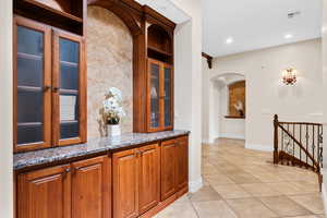 Bar area with light tile patterned flooring and french doors