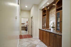 Corridor with light tile patterned floors