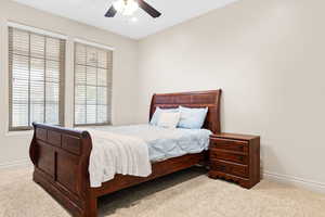 Bedroom with carpet, multiple windows, ceiling fan, and recessed lighting