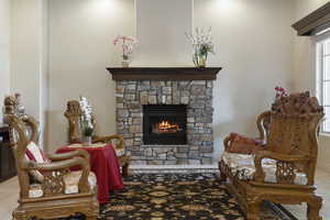 Living area featuring a stone fireplace