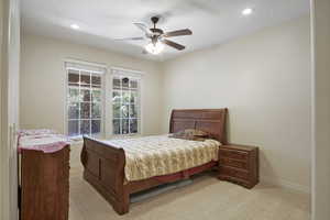 Guest bedroom featuring a ceiling fan and natural light