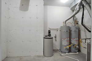 Utility room featuring strapped water heater