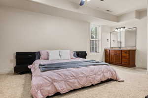 Bedroom with light carpet and a ceiling fan