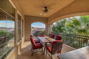 View of patio featuring ceiling fan and a balcony