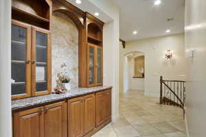 Hallway featuring tile floors