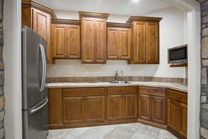 Kitchen featuring sink and stainless steel refrigerator