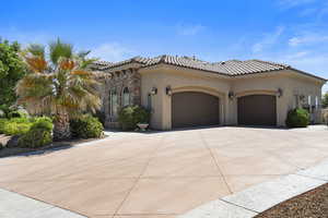 Mediterranean / spanish home featuring a garage