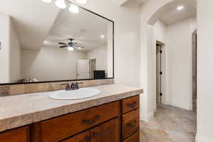 Bathroom with vanity, ceiling fan, and recessed lighting