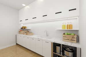 *Virtually Staged Butler Pantry* Kitchen featuring light countertops, light flooring, and white cabinetry