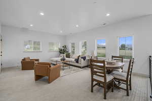 Living room with a wealth of natural light and carpet