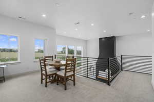 Dining room with carpet and natural light