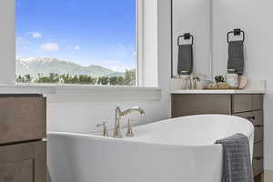 Bathroom with a tub and mirror