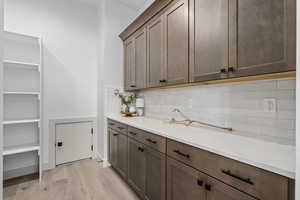 Kitchen with light hardwood flooring and light countertops