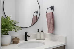 Bathroom featuring dual mirrors and vanity with extensive cabinet space