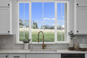 Kitchen with plenty of natural light, light countertops, and white cabinetry