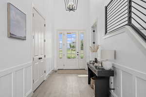 Wood floored foyer featuring natural light